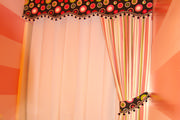 Pink bathroom with horizontal stripes, pink and black topper with striped curtain
