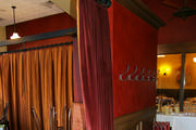 Red velvet drapery panels to divide areas in a restaurant. The lining is a red and gold stripe. All rings are hand sewn on at each pleat.
