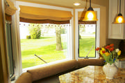 In this bay window, roman shades were the perfect choice for this south facing window. 

