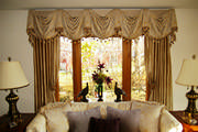 Swagged valance attached to a cornice with silk drapes is just the right amount of elegance for this living room.
